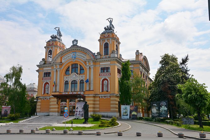 Cluj - walking city tour - Museum Square, Franciscan church, and the Carolina Obelisk